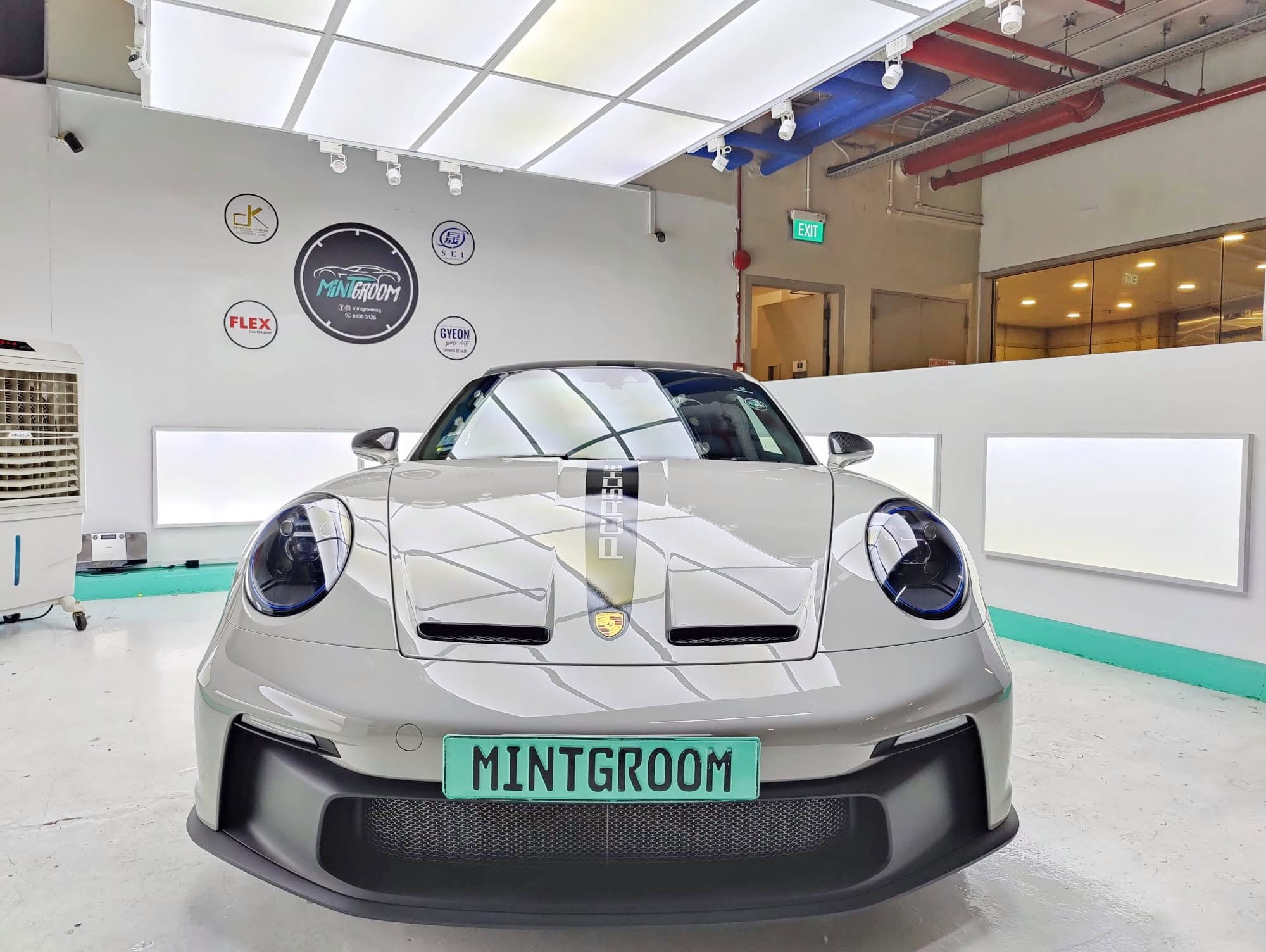 Grey Porsche 911 GT3 with a mint MintGroom plate in the MintGroom studio