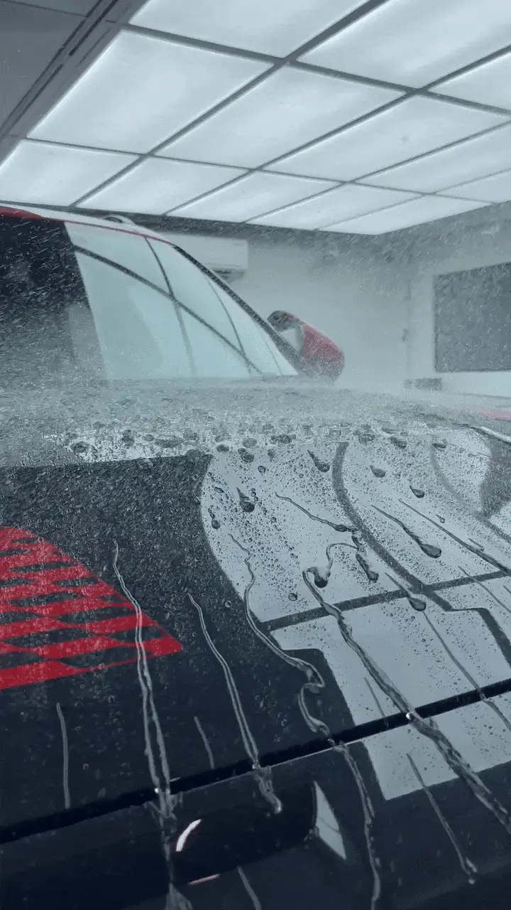 Water beading off a freshly coated car bonnet